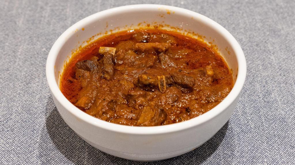 Lamb Or Goat Curry · Lamb or goat cooked in a mild spice.