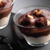 Profiteroles Cup · A layer of vanilla cream topped with cream puffs covered in chocolate.