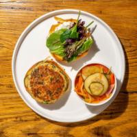 Salmon Burger · Homemade tartar sauce, house pickles, and mixed greens on a sweet potato bun. Add bacon or a...