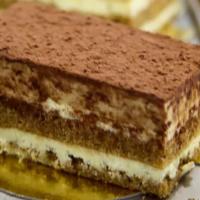 Tiramisu Mini · Mascarpone filling layered with espresso soaked sponge cake and coffee cream, dusted with co...