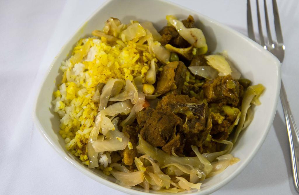 Curry Goat · Includes two sides.
