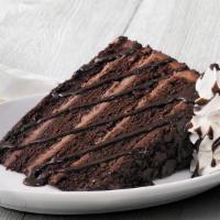 New! Chocolate Overload Cake · Four rich, dark chocolate, melt-in-your-mouth cake layers stacked high with sweet milk choco...