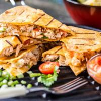 The Fried Chicken Quesadilla · Fried chicken, melted cheese, onions, cilantro, and tomatoes stuffed in between a warm wrap,...