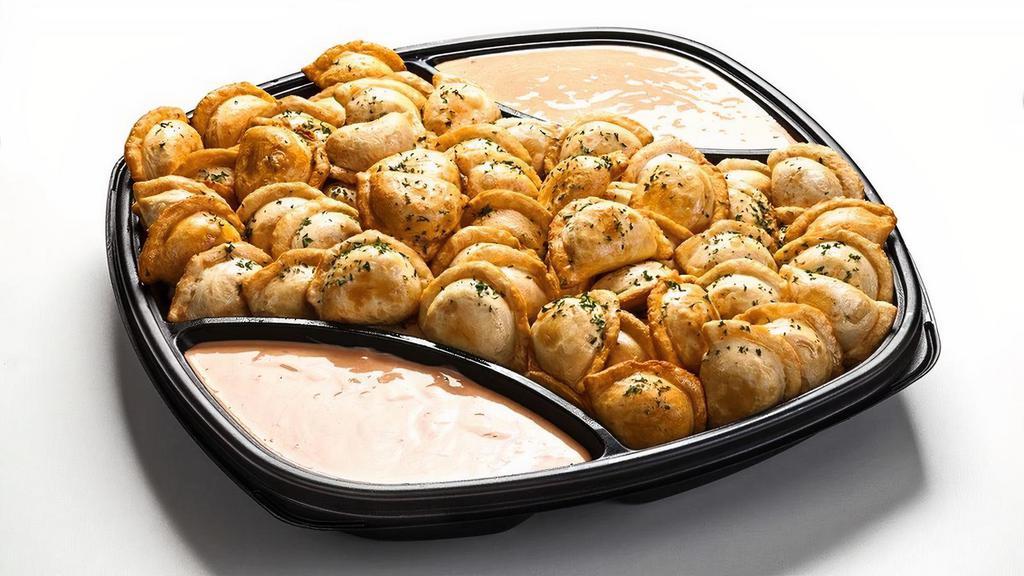 Amish Perogies · Traditional dumplings made with real mashed potatoes and 3 real cheeses. Served with sweet chili sour cream sauce. Tray accommodates 10-12.