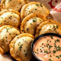 Amish Perogies · Traditional real cheese & potato dumplings, house-made sweet chili sour cream