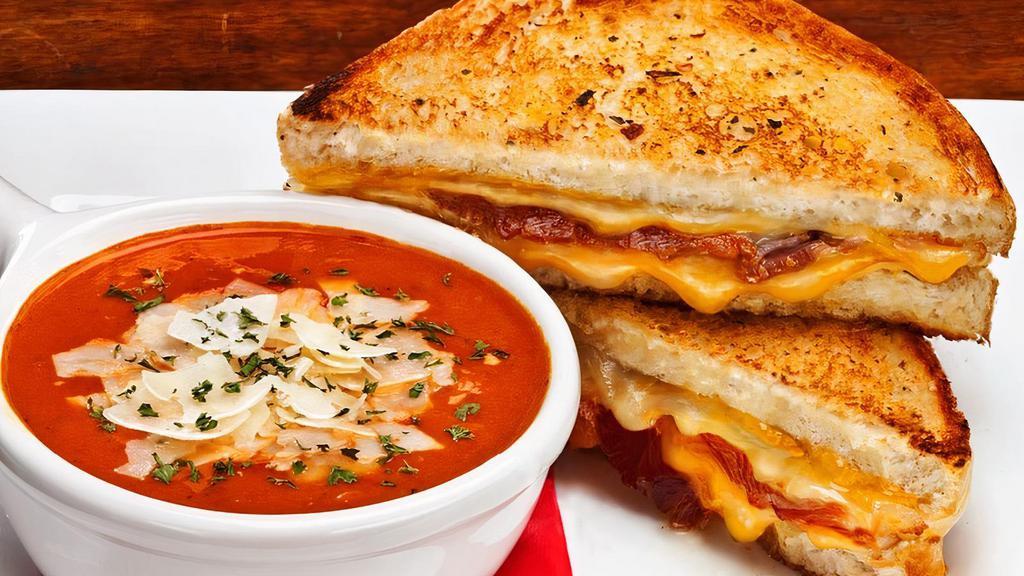 Grilled Cheese & Soup · Double-grilled thick-cut sourdough, smoked Gouda, cheddar, American cheese, provolone, applewood smoked bacon, tomato basil soup, shaved Parmesan