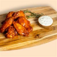 Another Garlic In The Wall · Our famous wings fried until perfectly golden. Tossed in garlic sauce, served with your choi...