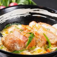 Katsu Donburi  · 6.5 oz. 180 gm. Pork loin served with egg, onions, scallions in our dashi broth over white r...