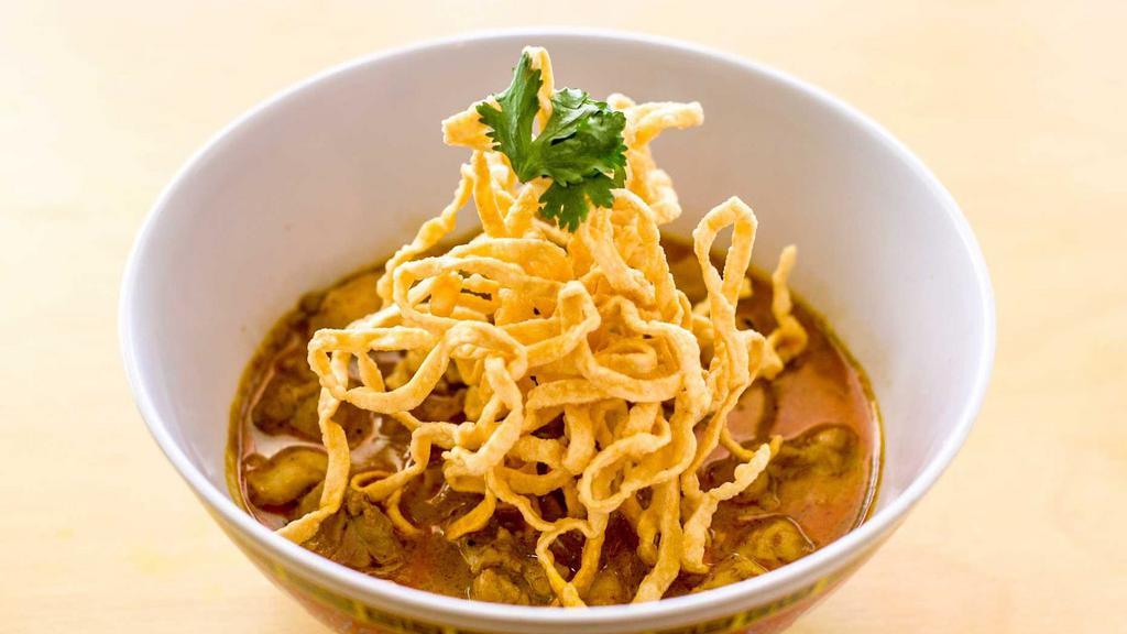 Khao Soi · Red curry, coconut milk, chicken, egg, noodles, pickled mustard greens, red onions