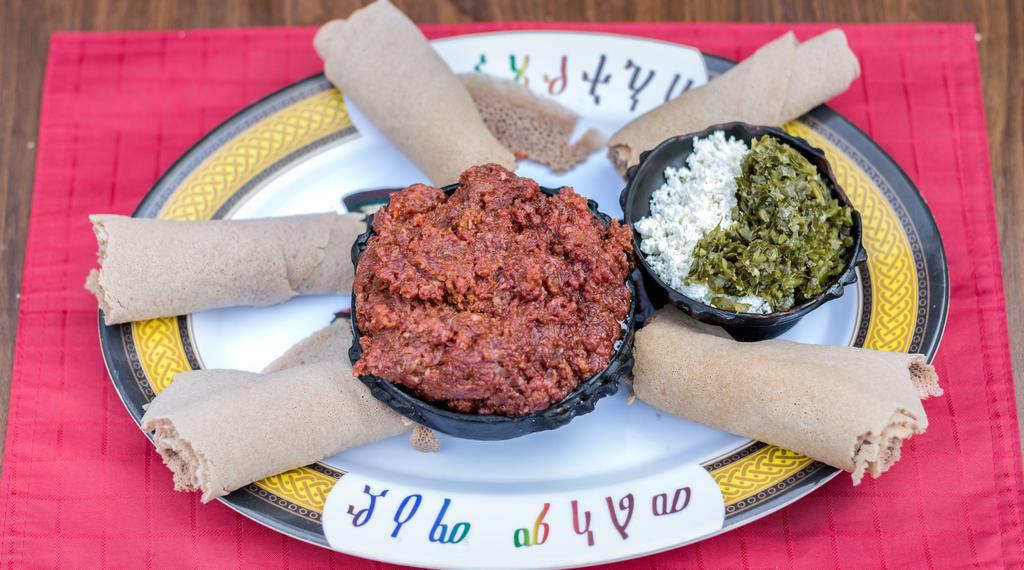 Kitfo · Finely chopped prime lean beef seasoned with herbed butter sauce and spices served with Ethiopian feta cheese. Prepared rare, medium, and well done.