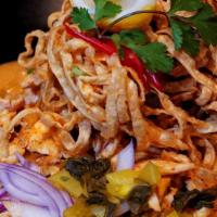 Kao Soy · Chicken, egg noodle, red onion and pickle with spicy Thai nothern curry.