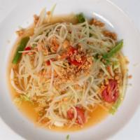 Papaya Salad · Thai style green papaya salad with tomatoes carrot, string beans and crushed peanut in tangy...
