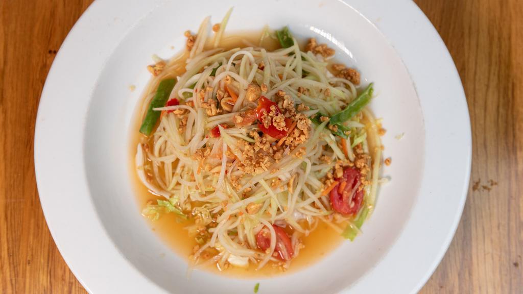 Papaya Salad · Thai style green papaya salad with tomatoes carrot, string beans and crushed peanut in tangy lime juice dressing. Spicy.