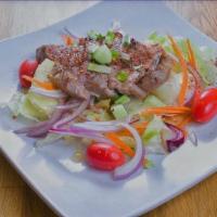 Grilled Beef Salad · Cucumber, red onion, carrot, tomatoes, mint, spicy Thai lime dressing.