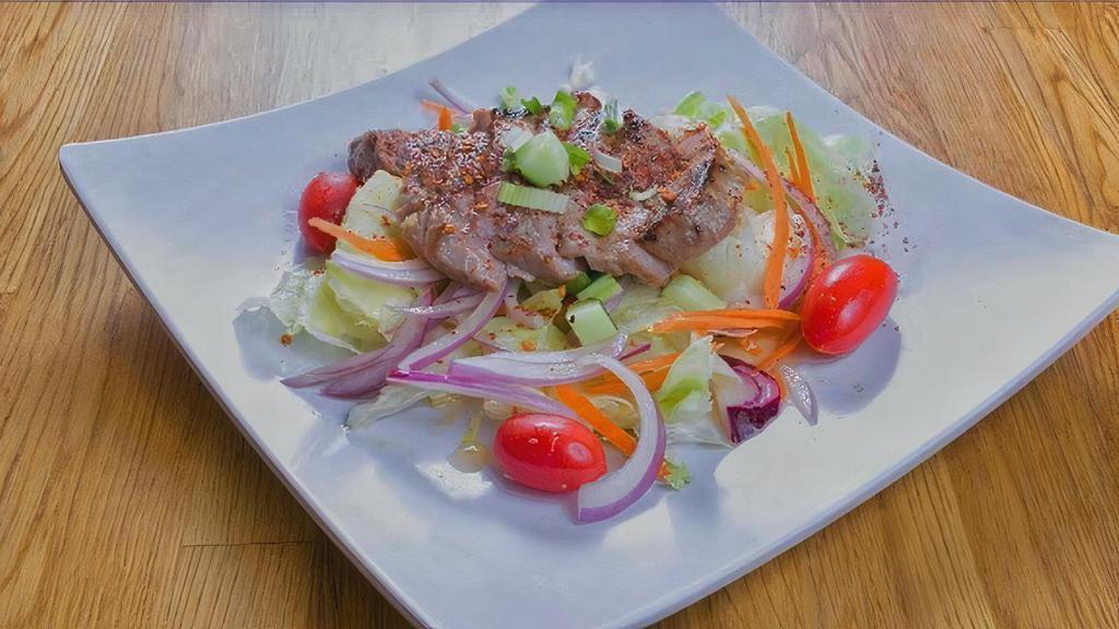 Grilled Beef Salad · Cucumber, red onion, carrot, tomatoes, mint, spicy Thai lime dressing.