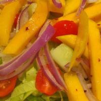 Mango Salad · Mango, onion, peanut and lettuce in sweet lime dressing.