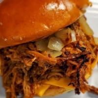 Pulled Pork Sandwich · Bbq pulled pork yellow american cheese grilled onions on hamburger bun.
