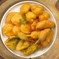 Pillars Of Pakora · Assorted vegetables dipped in a light batter and fried until golden brown.