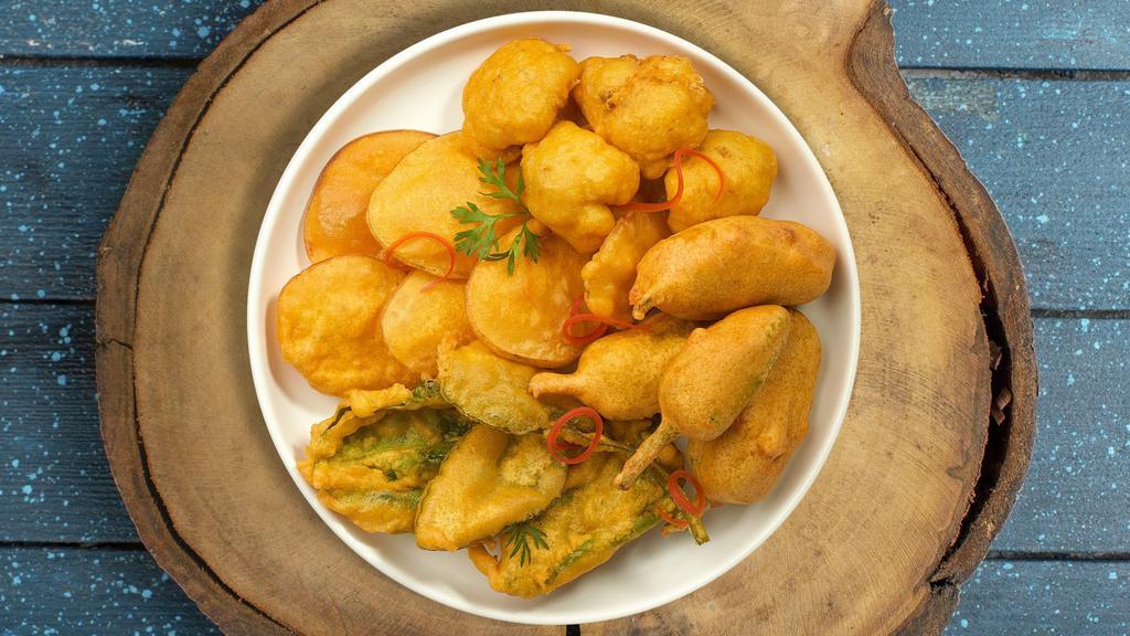 Pillars Of Pakora · Assorted vegetables dipped in a light batter and fried until golden brown.