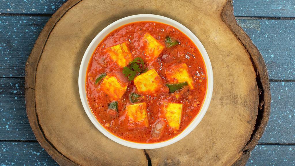 Kadai Kick Paneer · Tender cottage cheese pieces stir fried with bell peppers, onions, & tomatoes in a light gravy.