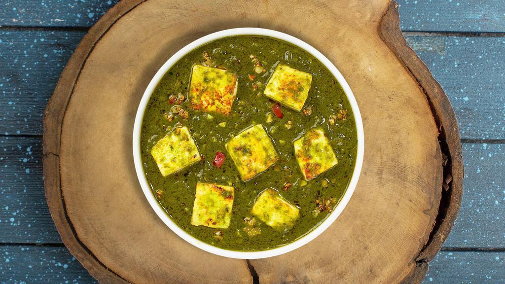 Saag Sleuths Paneer · Slow-cooked spinach and mustard greens with fresh ginger, paneer and garlic.