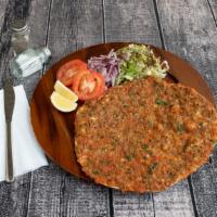 Lahmacun (Lah-Mah-Joun) · round, thin piece of dough topped with mixed meat, mixed vegetables and herbs including onio...