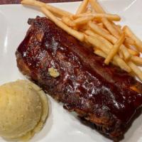 Full Rack Slow Roasted Baby Back Ribs · Slow roasted BBQ ribs slathered in our sweet and tangy BBQ sauce served with potato of your ...