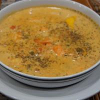 Chupe De Camarones · shrimp soup with milk, eggs, rice and mixed vegetables
