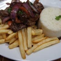 Lomo Saltado · Beef stir-fried dish sauteed with onions, tomatoes, and French fries served with white rice