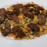 Chaufa De Carne · Steak served with rice, scallions, ginger, red peppers, and soy sauce