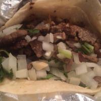 Taco De Bistek · With cilantro and onions.