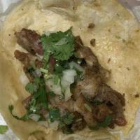 Taco Al Pastor · With cilantro and onions.