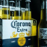 Corona Extra · Corona is a brand of beer produced by Mexican brewery Cervecería Modelo and owned by Belgian...