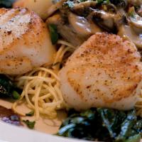 Fresh Sea Scallops Over Angel Hair · fresh sea scallops sauteed with spinach and mushrooms in a madiera cream sauce over angel ha...