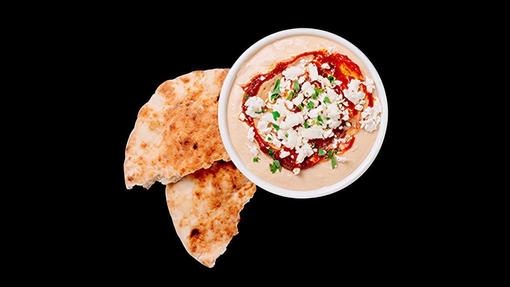 Spicy Feta Hummus With Pita · Creamy hummus made from fresh chickpeas, garnished with our spicy Red S'hug sauce, feta, and parsley with pita bread.