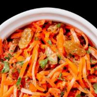 Curried Carrot Salad · Sweet shredded carrots, golden raisins, amba, and parsley