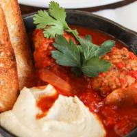 Israeli Meatballs · Meatballs with Red Peppers and tomato sauce, green peas and hummus,
toasted bread