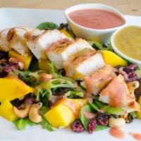 Tropical Chicken & Mango / Pollo C/ Mango Tropical / Choice Of Passion Fruit Or Guava Vinaigrette · Spring mixed greens with grilled chicken breast, mango slices, dried cranberries, and cashews.