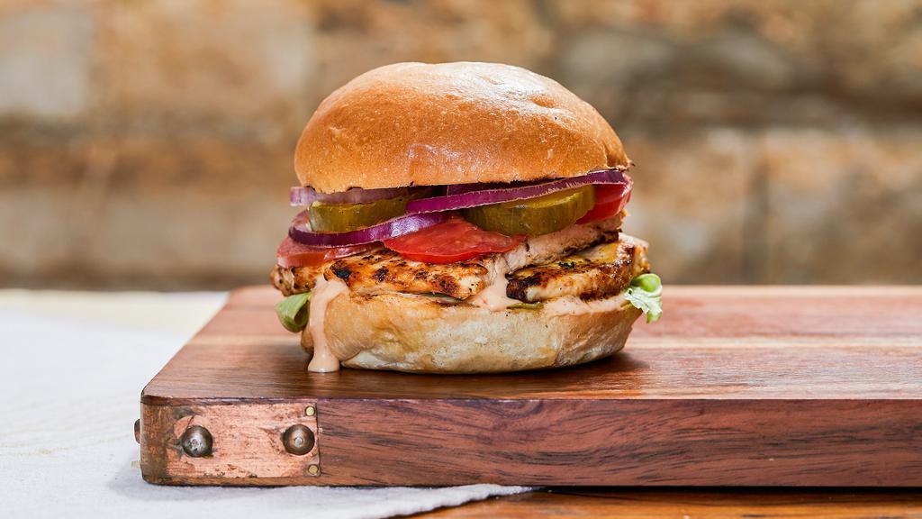 Grilled Chicken Burger · Boneless grilled or fried chicken with lettuce, tomato, onion, pickles, sauce served  on a bun.