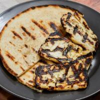 Grilled Halloumi Cheese · Three pieces of semi-hard grilled cheese from goat's and sheep's milk served with a pita bre...