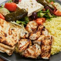 Chicken Souvlaki Platter · Ten pieces of juicy marinated chicken chunks, served with Greek salad and yellow rice or fri...