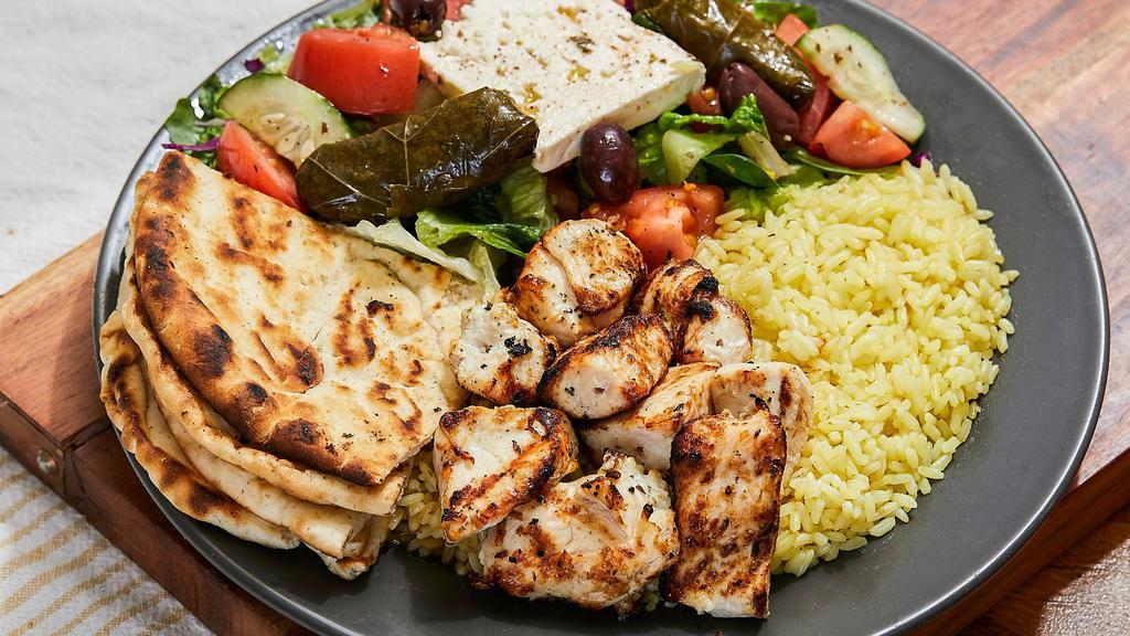 Chicken Souvlaki Platter · Ten pieces of juicy marinated chicken chunks, served with Greek salad and yellow rice or fries. The platter comes with a side pita bread and our homemade white sauce (tzatziki).