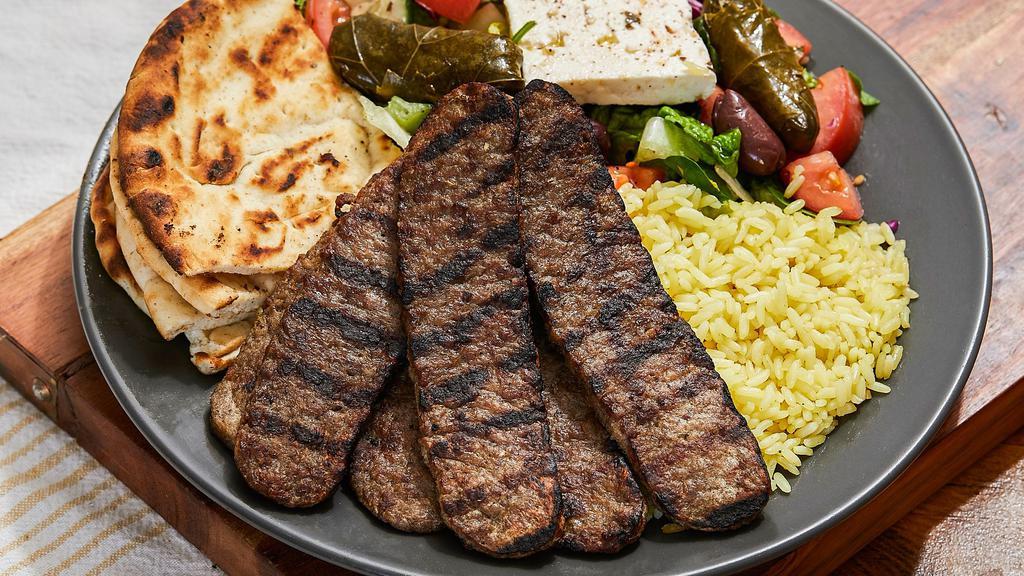 Lamb Gyro · Six pieces of juicy lamb gyro served with Greek salad and yellow rice or fries. The platter comes with a side pita bread and our homemade white sauce (tzatziki).