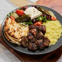 Pork Souvlaki  Platter · Ten to twelve pieces marinated pork chunks served with Greek salad and rice or fries. The pl...