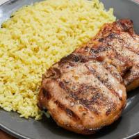 Pork Chops · Two juicy marinated pork chops served with a choice of yellow rice, fries or Greek lemon pot...