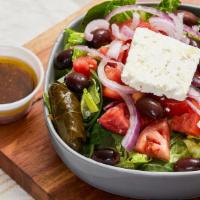 Greek Salad · Mix Greens, Tomatoes, Cucumber, Olives, Feta Cheese, Dolmades, House Evoo Vinaigrette.