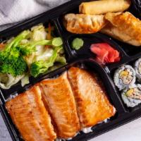 Salmon Bento · Bento box featuring your choice of teriyaki comes with four pieces of California roll, two p...