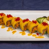 Golden Apple Roll · Spicy crunchy salmon, Fuji apple inside, topped with fresh mango and amazing sauce