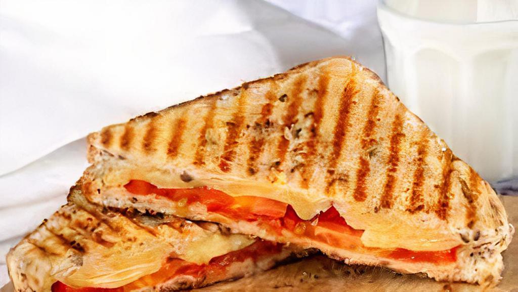 Grilled Cheese With Tomato · Your Choice of Cheese And Sliced  Tomato between two slices of bread, heated until the bread browns and the cheese melts.
