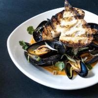 Steamed Prince Edward Island Mussels · Red coconut curry broth, charred bread, cilantro